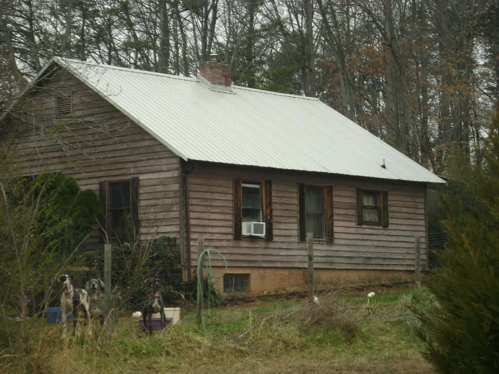 White metal roof on an old wood sided farmhouse, from a Asphalt Shingle Roof Repair job in Greencastle